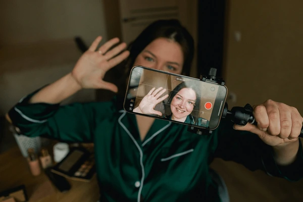 woman applying makeup and making content herself